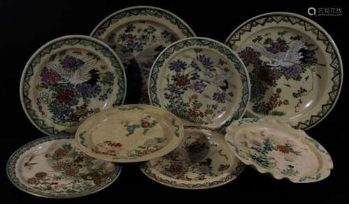 A pair of Japanese late Meiji period pottery plates, to include one of circular form decorated