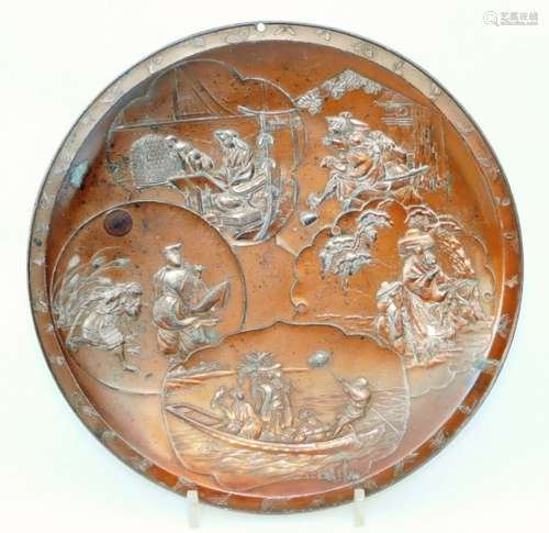 An early 20thC Japanese metal dish, of circular form raised with panels of figures with a brushed