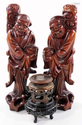 A similar pair of root carvings of sages, each standing on naturalistic settings in flowing robes,