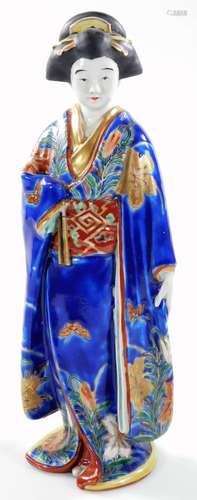 A Japanese semi porcelain figure, of a standing Geisha in flowing robes, decorated with