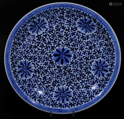 A Chinese porcelain dish, of circular form, profusely decorated with flowers in entwined stems