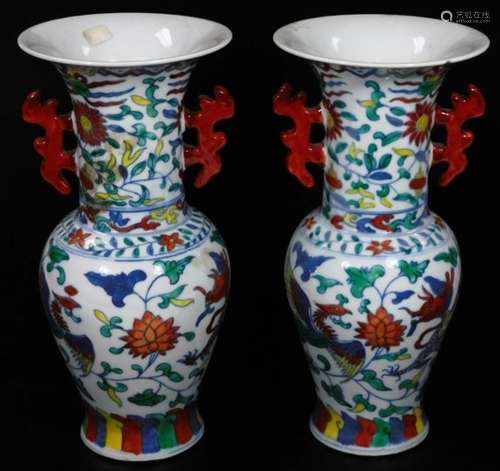 A pair of Chinese porcelain vases, each with a trumpet stem and shouldered circular body, polychrome