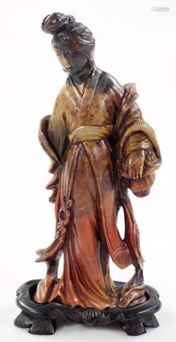 A Meiji period Japanese soapstone figure of a geisha, wearing flowing robes, on a shaped