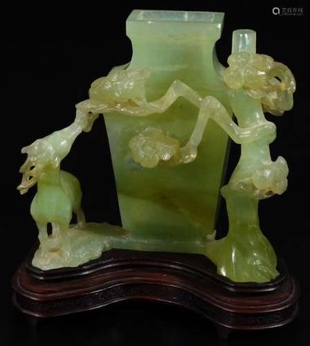 A Jade carving of a vase and entwined flowers, on a removable base, the main body 15cm H.