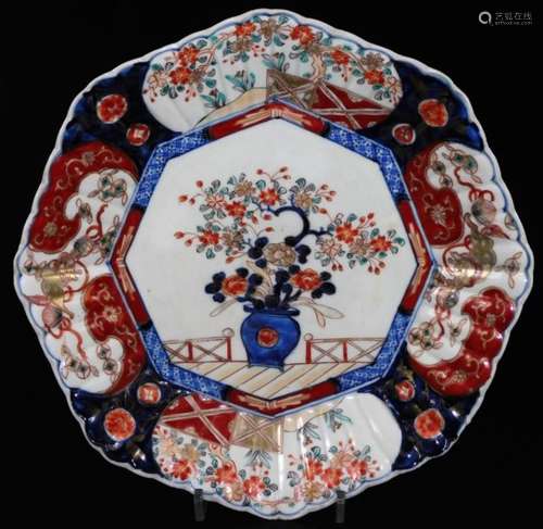 A Japanese Imari plate, of octagonal form, centred with a vase of flowers with a floral border,