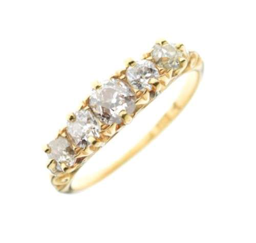 Yellow metal and five-stone diamond ring, set five old European cut stones within scroll setting,