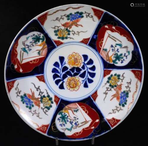 A Japanese Imari pottery Meiji type dish, of circular form, centred by entwined flowers with an