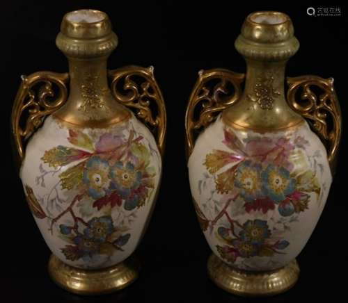 A pair of early 20thC blush ivory pottery vases, with inverted stems, pierced scroll handles and