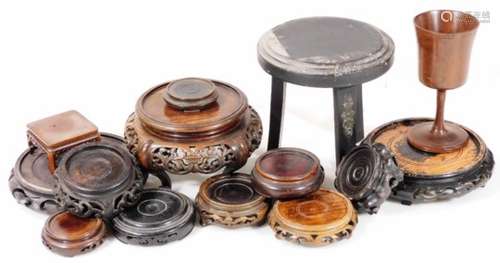 Various early 20thC carved wooden Chinese stands, a highly elaborate carved stand on inverted