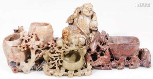 A Chinese carved soapstone figure, of a sage seated in flowing robes holding staff, 10cm H, on a