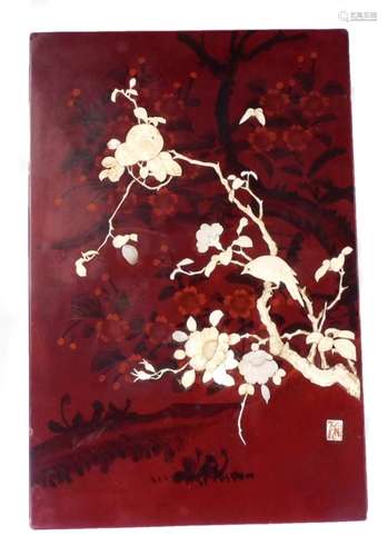 An early 20thC Japanese red lacquer and ivory Japanned panel, of rectangular form raised with