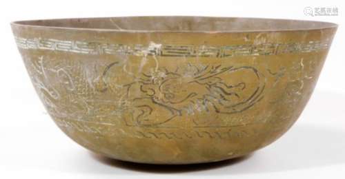 A Chinese metal bowl, profusely decorated with a banding of dragons, with an upper Greek key style