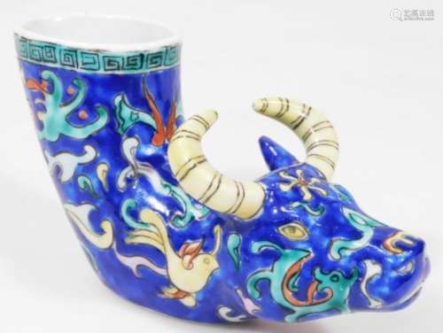 A Chinese porcelain libation cup, of small proportion in the form a horned cow, decorated in blue,