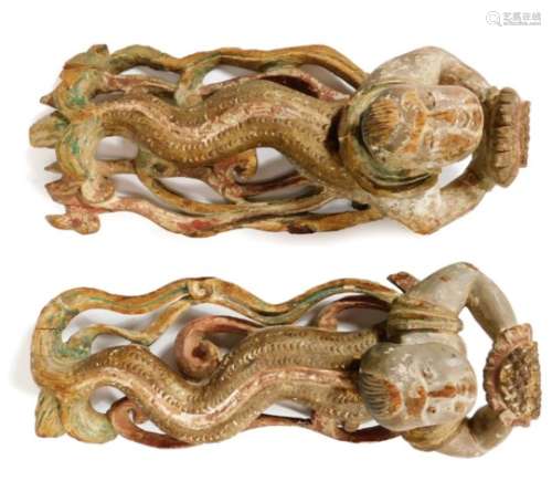 A pair of heavily carved Javanese wooden serpent child nymphs, each looking upwards on similar