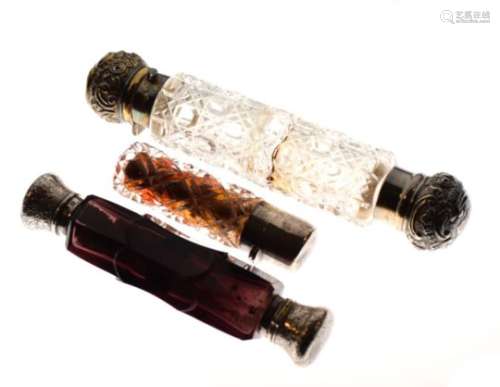 Two double ended scent or sal volatile bottles, the larger Victorian, the silver collars (previous