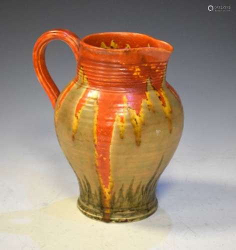 Crown Devon pottery jug of bulbous form decorated in a red and orange drip glaze to the banded body,