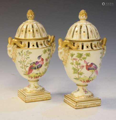 Pair of 19th Century creamware urns and covers, each with pierced domed cover and neo classical