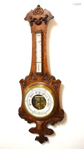 Late 19th/early 20th Century oak cased aneroid barometer having mercury thermometer with ceramic