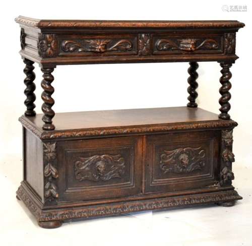 Late 19th Century carved oak carved buffet, the upper fitted two carved mask head drawers with