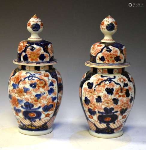 Pair of 19th Century Imari baluster shaped vases and covers having decoration of flowers with gilt