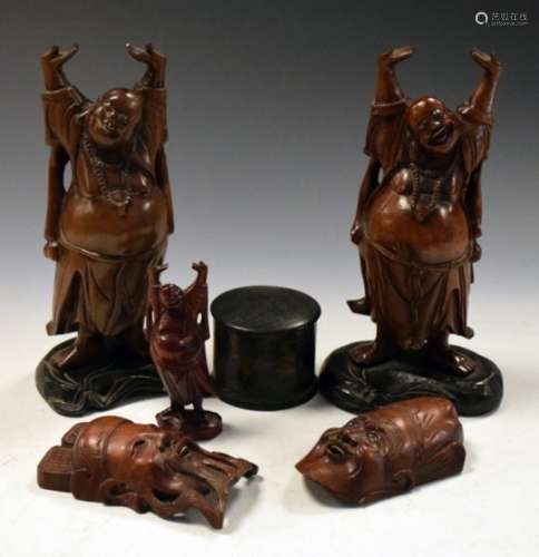 Pair of Oriental carved hardwood figures of gods, modelled and standing posed with arms aloft, on