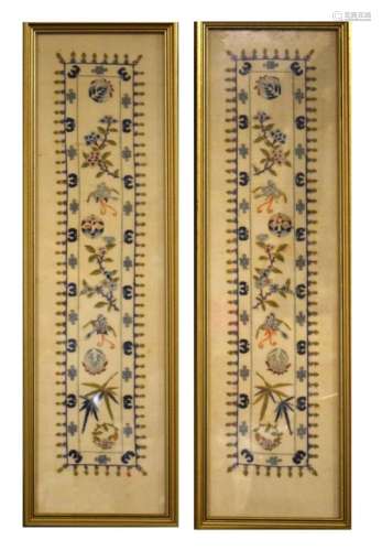 Pair of Chinese-style embroidered panels of sleeve type decorated with flowering plants, 53.5cm