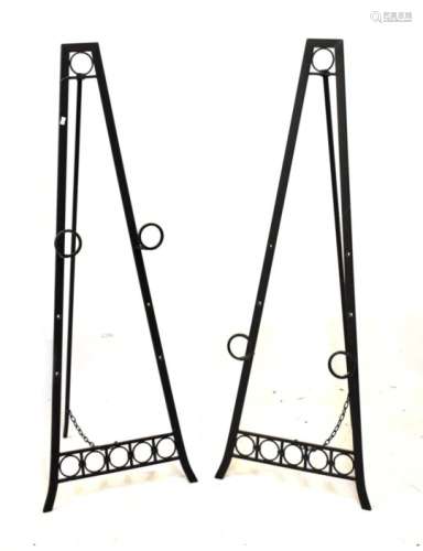 Pair of wrought iron easel stands, 133cm high