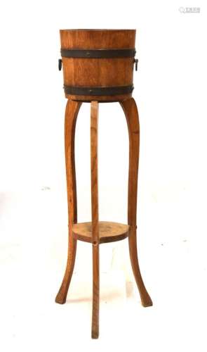 Early 20th Century oak jardinière on stand of coopered design with makers plaque R.A. Lister & Co