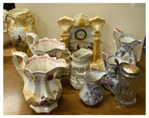 Pottery mantel clock, a collection of various 19th Century jugs including a Charles Meigh Gothic