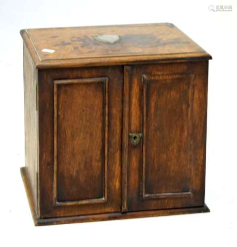 Early 20th Century oak smoker's cabinet fitted two doors, the top with unengraved silver plated