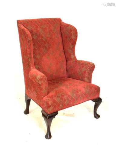 Antique wing back armchair raised on walnut cabriole front supports with later similarly upholstered