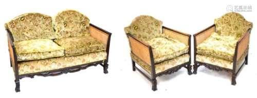 Early 20th Century mahogany bergere suite comprising two seater settee and pair of armchairs
