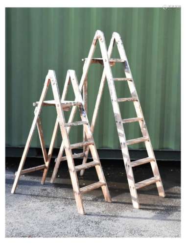 Two pairs of wooden folding step ladders