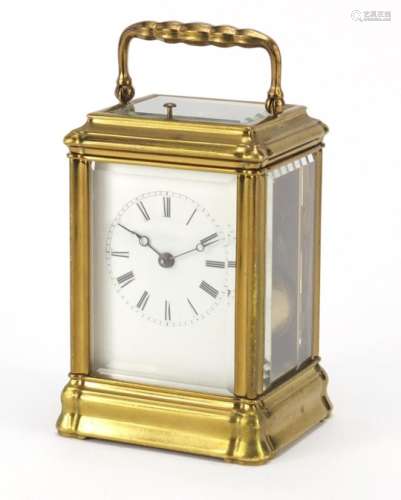 Brass cased repeating carriage clock striking on a gong having an enamel dial with Roman numerals,