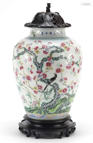 Chinese porcelain vase with carved hardwood lid and stand, finely hand painted in the famille rose