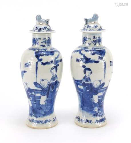 Pair of Chinese blue and white baluster vases with covers, hand painted with figures, blue ring
