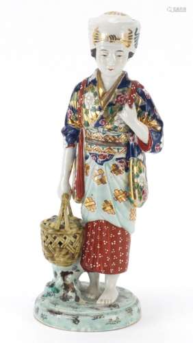 Japanese porcelain figurine of a girl holding a basket, 33cm high : For Further Condition Reports