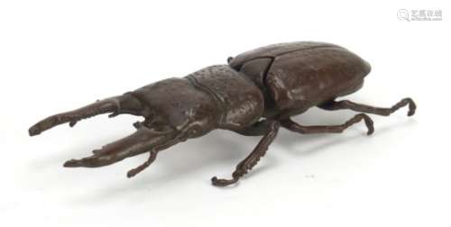 Japanese patinated bronze stag beetle with articulated wings, character marks to the underside, 13.