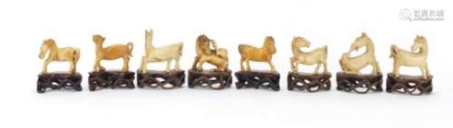 Eight Chinese carved ivory horses raised on carved hardwood stands, the largest approximately 6cm