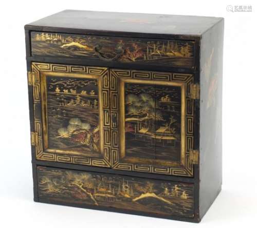 Japanese black lacquered table cabinet, gilded with landscapes, 34cm high x 33cm wide x 18cm
