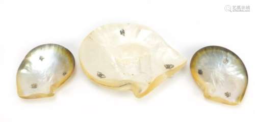Three Chinese mother of pearl shell dishes with unmarked silver feet, the largest 19.5cm wide :