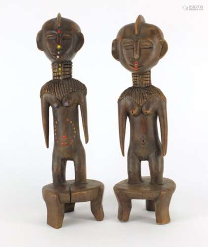 Pair of African tribal carved wood and beadwork fertility figures, the largest 37cm high : For