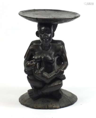 African stool carved with a nude mother feeding, 52.5cm high x 36cm diameter : For Further Condition