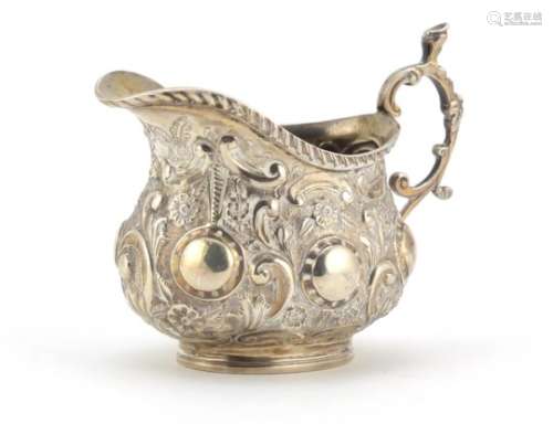 Victorian silver cream jug embossed with flowers, indistinct maker's mark, London 1900, 6cm high,
