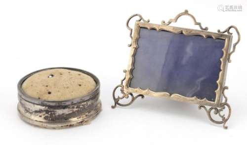 Edwardian silver easel photo frame and a circular silver pin cushion, the photo frame hallmarked