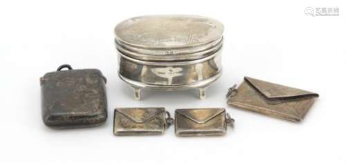 Silver items comprising three stamp cases in the form of envelopes, a Victorian Vesta and a jewel