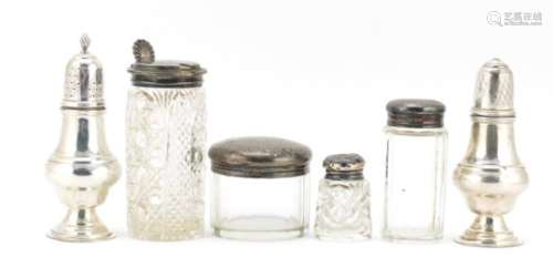 Silver items including two baluster shaped casters, three cut glass jars with silver lids and a