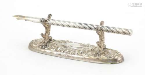 Edwardian silver dip pen on a silver pen rest, Chester 1904, the pen 15.5cm in length : For
