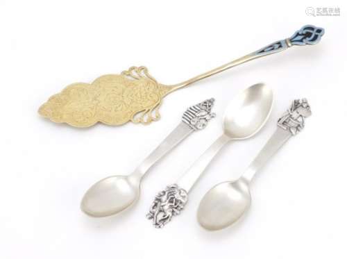 Three Danish silver spoons and a silver gilt cake slice with enamelled handle, the spoons with JG
