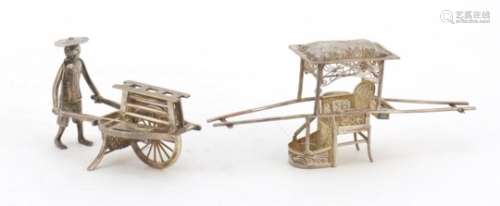 Chinese silver model of a figure pushing a cart and a filigree metal carriage, the largest 11cm in